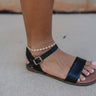 side view of female model wearing the Harmony Gold & Pearl Heart Chain Anklet which features adjustable gold and pearl heart chain anklet