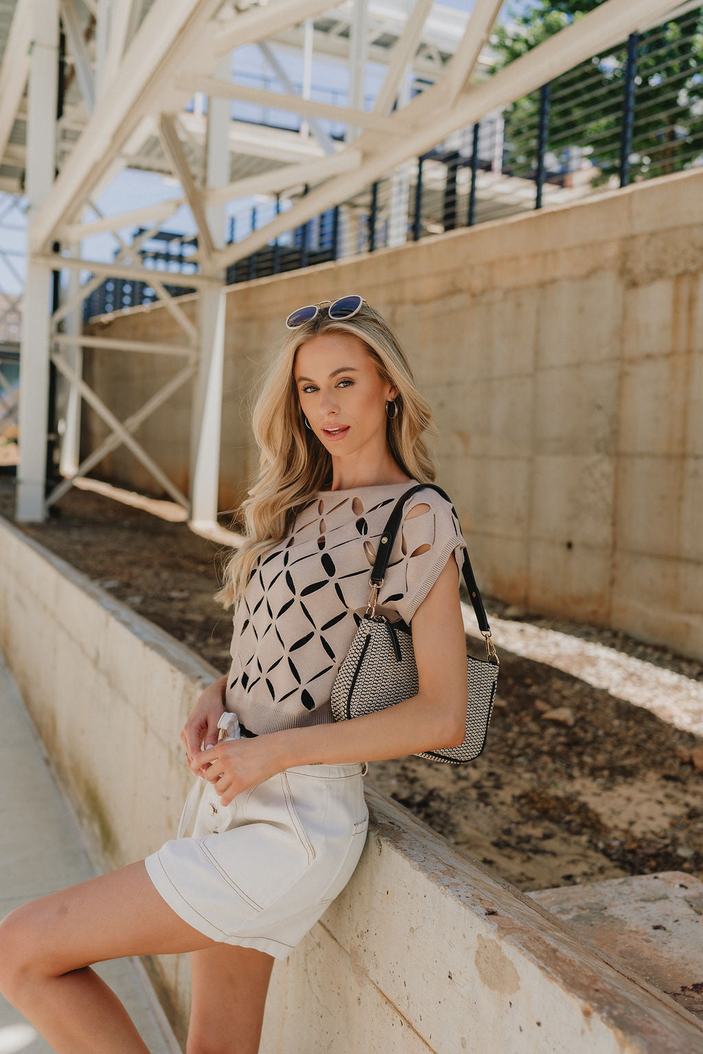 Side view of Emme Taupe Short Sleeve Top that has cut out details throughout.