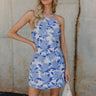 Front view of Lexi Blue Floral Mini Dress that has floral monochrome, white and blue, tied criss-cross  back, and spaghetti straps.