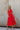 Full body front view of Lucy Red One Shoulder Midi Dress that has one shoulder and open front, bow detail on the front, elegant look.