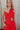 Close up of bow on Lucy Red One Shoulder Midi Dress that has one shoulder and open front, bow detail on the front, elegant look.