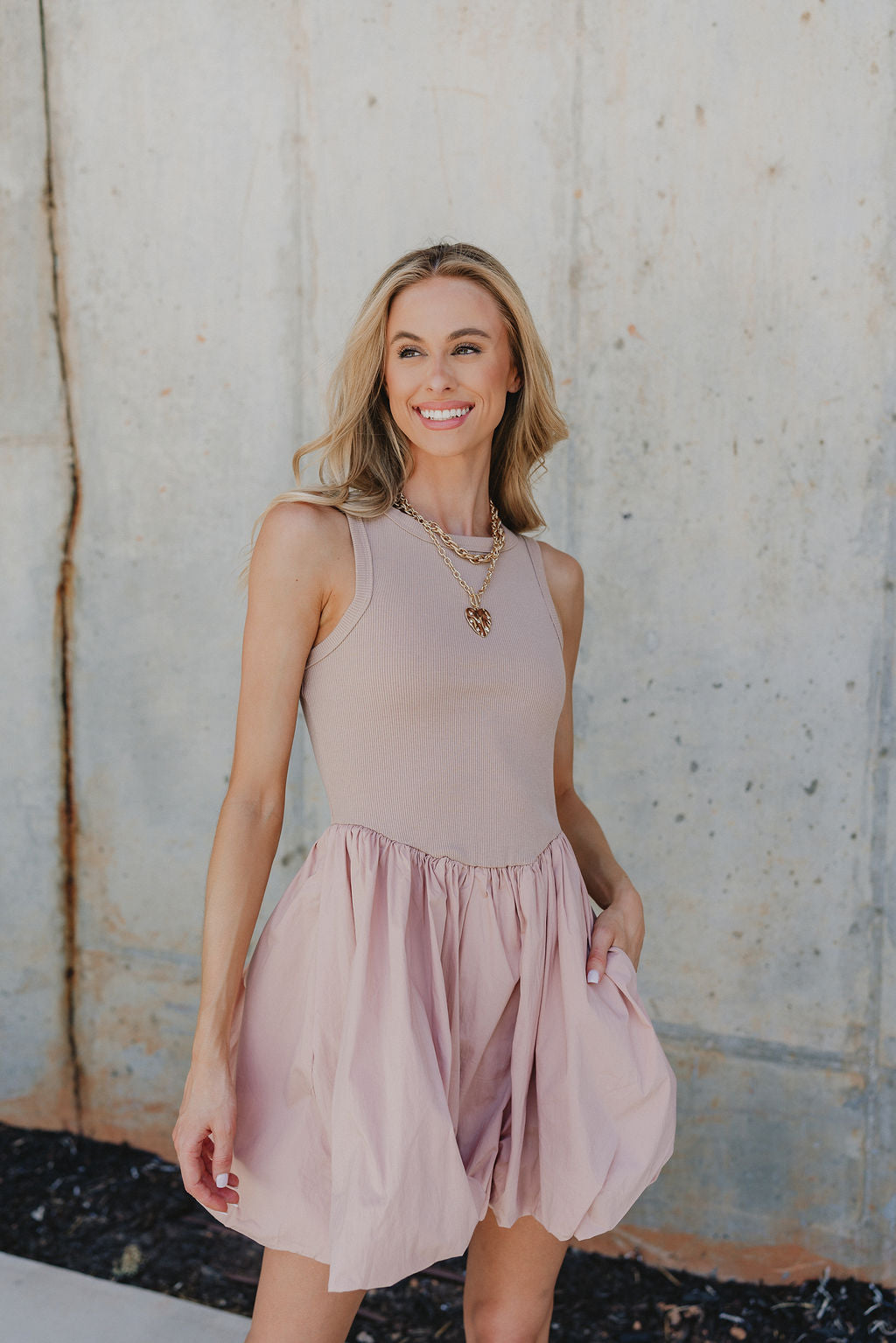 Close up of Rylee Mauve Mini Dress that is mauve pink, with a bubble hem, ribbed upper body, and mini length