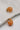 Close up view of the Sophie Peach Scoop Hoop Earring which features peach scooped mini hoops