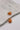 Close up view of the Sophie Peach Scoop Hoop Earring which features peach scooped mini hoops