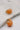 Close up view of the Sophie Peach Scoop Hoop Earring which features peach scooped mini hoops