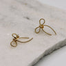 Close up view of the Alice Gold Roped Bow Stud Earring which features gold roped bow shaped studs