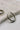 close up view of the Luna Silver Oval Hoop Earring. the earring features silver medium open hoops