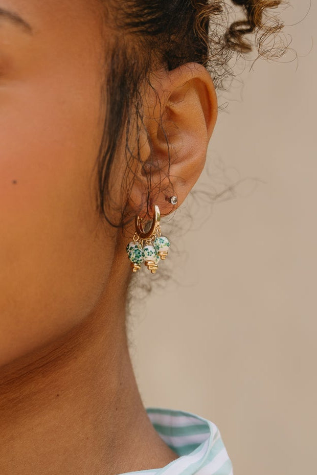 Molly Floral Beaded Huggie Earrings - close up of earrings on model