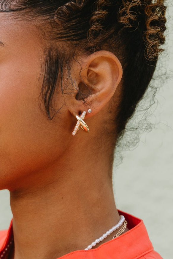 Tiana Gold & Pearl Criss Cross Earrings - close up of earrings on model