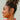Tiana Gold & Pearl Criss Cross Earrings - side view of earrings on model