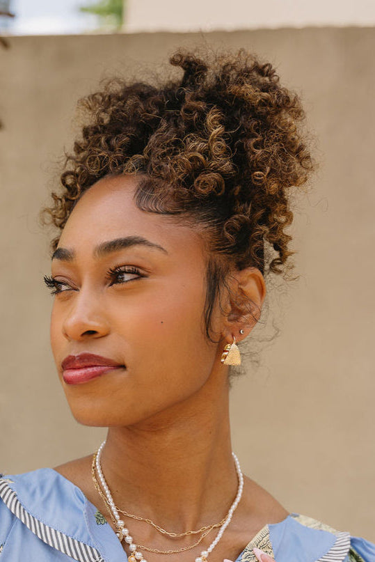 Sami Hammered Gold Hoop Earrings - front view of earrings on model