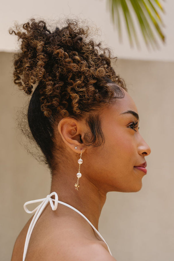 Hillary Floral Beaded & Bow Dangle Earrings - side view of earrings on model