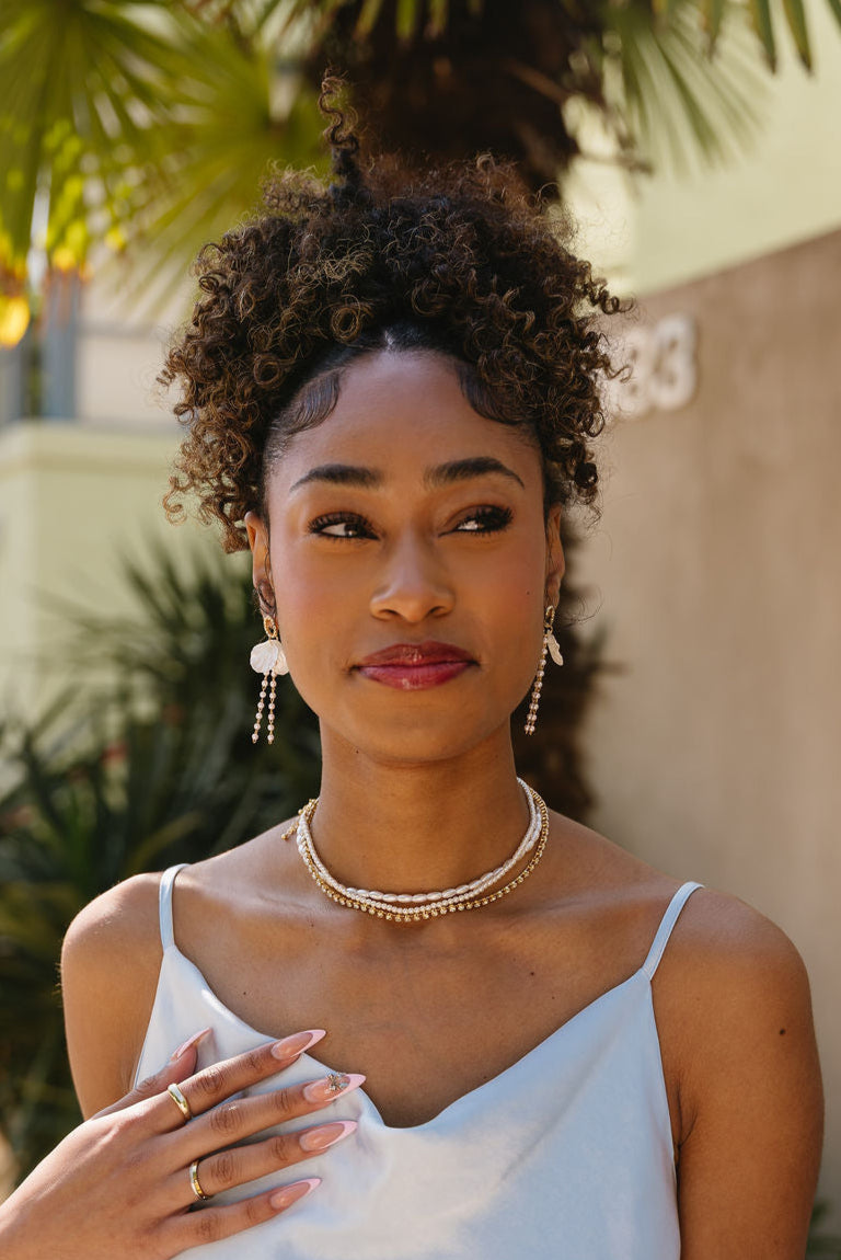 Jesslyn White Petal & Pearl Earrings - front view of model wearing earrings