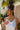 Jesslyn White Petal & Pearl Earrings - side of model wearing earrings