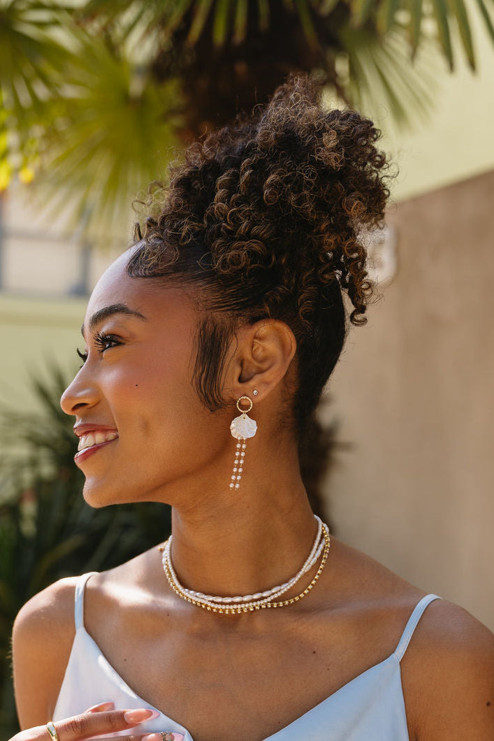 Jesslyn White Petal & Pearl Earrings - side view of model wearing earrings