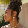 Jesslyn White Petal & Pearl Earrings - side view of model wearing earrings