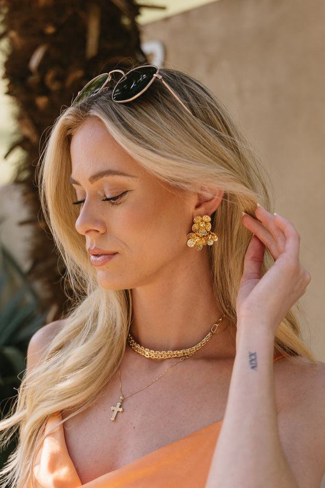 Jemma Gold Flower Stud Earrings - side view of model wearing earrings
