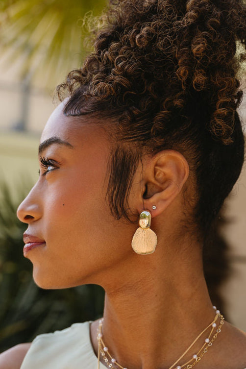 Ariel Gold Petal Earrings - close side view of model wearing earrings
