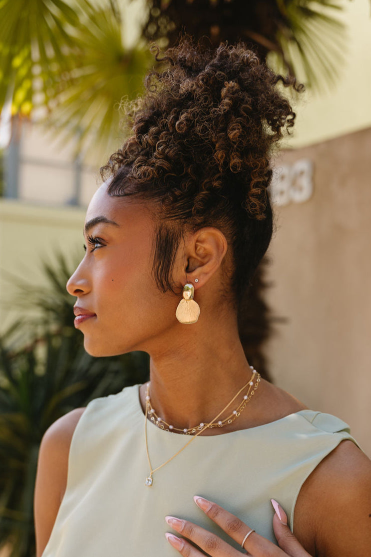 Ariel Gold Petal Earrings - side view of model wearing earrings