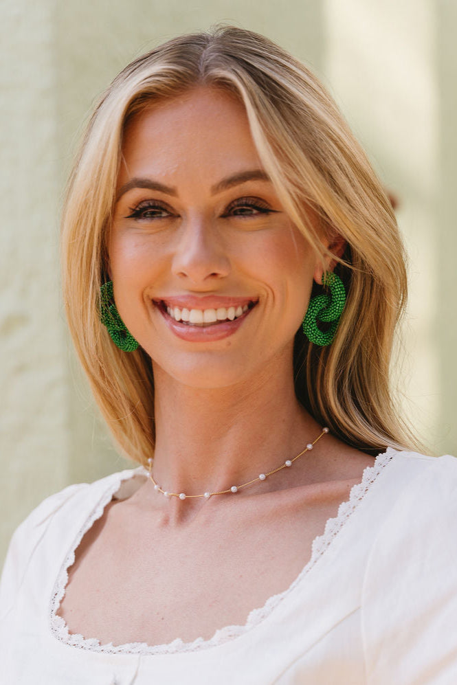 Jana Green Beaded Circle Earrings - close front view of model wearing earrings