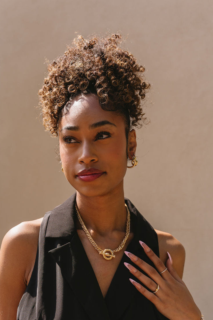 Bianca Gold Twisted Knot Earrings - front view of model wearing earrings