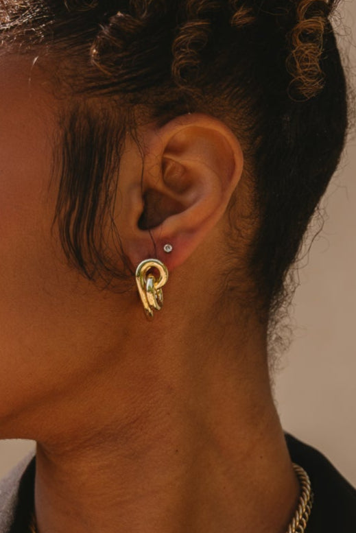 Bianca Gold Twisted Knot Earrings - close up of model wearing earrings