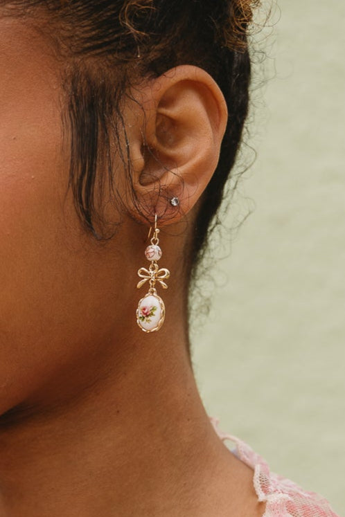 Cady Vintage Floral Bow Earrings - close up on model