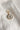Image shows the 'V' alphabet charm against a white background. Charm is a gold circle with pearlescent center and has gold letter V in the center.
