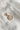 Image shows the 'L' alphabet charm against a white background. Charm is a gold circle with pearlescent center and has gold letter L in the center.
