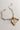Image shows Leanne Gold Oval Chain Link Bracelet laid out against a white background. Bracelet has has 3 assorted charms attached.