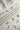 Image shows 3 chain necklaces laid out with assorted charms on each side. Shown against a white background