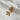 Image shows gold airplane charm against a white background.