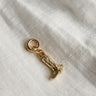 Image shows gold cowgirl boot charm against a white background.