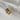 Image shows gold bow charm against a white background.