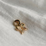 Image shows gold bow charm against a white background.