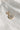 Image shows the 'U' alphabet charm against a white background. Charm is a gold circle with pearlescent center and has gold letter U in the center.