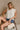 Becca Cream Eyelet Button-Up Tank Top - front view of model sitting