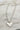Close up of Mama Silver Heart Necklace, adjustable silver chain link with a silver heart "MAMA" medallion.
