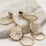 Close up of Zoey Opal Teardrop Dangle Earrings, gold chain link dangle earrings with opal teardrop medallions.