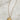  Close up of Selene Star and Moon Gold Necklace that has a adjustable gold chain link and a gold star medallion with a star and sun design