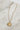  Close up of Selene Star and Moon Gold Necklace that has a adjustable gold chain link and a gold star medallion with a star and sun design