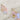 The Daisy Earrings are shown on a neutral background. The wire is gold, while the sequins cascading are iridescent pink.