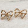 The Quincy Bow earrings sit against a neutral background.