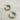 Earrings are shown on a neutral background. They are twisted hoops with blue, pink, yellow-orange, and green accents.