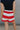 back view of female model wearing the Bristol Red & White Stripe Shorts which features Red and Cream Stripe Lightweight Fabric, Cream Lining, Elastic Waistband and Pockets on each side