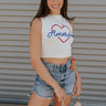 front view of female model wearing the Love America Cream Knit Tank which features Cream Knit Fabric, Round Neckline, Sleeveless and Red Stitch Heart, Says America in blue stitch writing