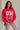 frontal side view of female model wearing the USA 1996 Red Long Sleeve Sweatshirt which features Lightweight Red Fabric, Round Neckline, Long Sleeves, Ribbed Hem and USA 1996 graphic with white, red and blue stitch design