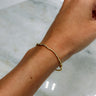 Image shows Jane Gold 2mm Beaded Water Resistant Bracelet on model's wrist.