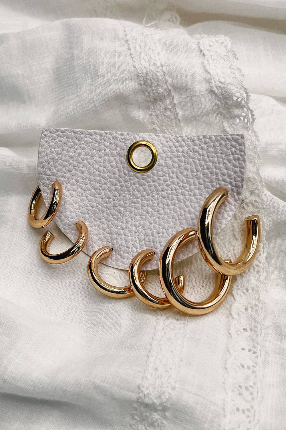 An alternate view of the Rochelle gold earring set. Featured are three sets of gold hoops varying in size.