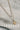 flat lay view of the Kendra Gold & White Stone Layer Necklace which features gold chain link with white beads and a sun medallion